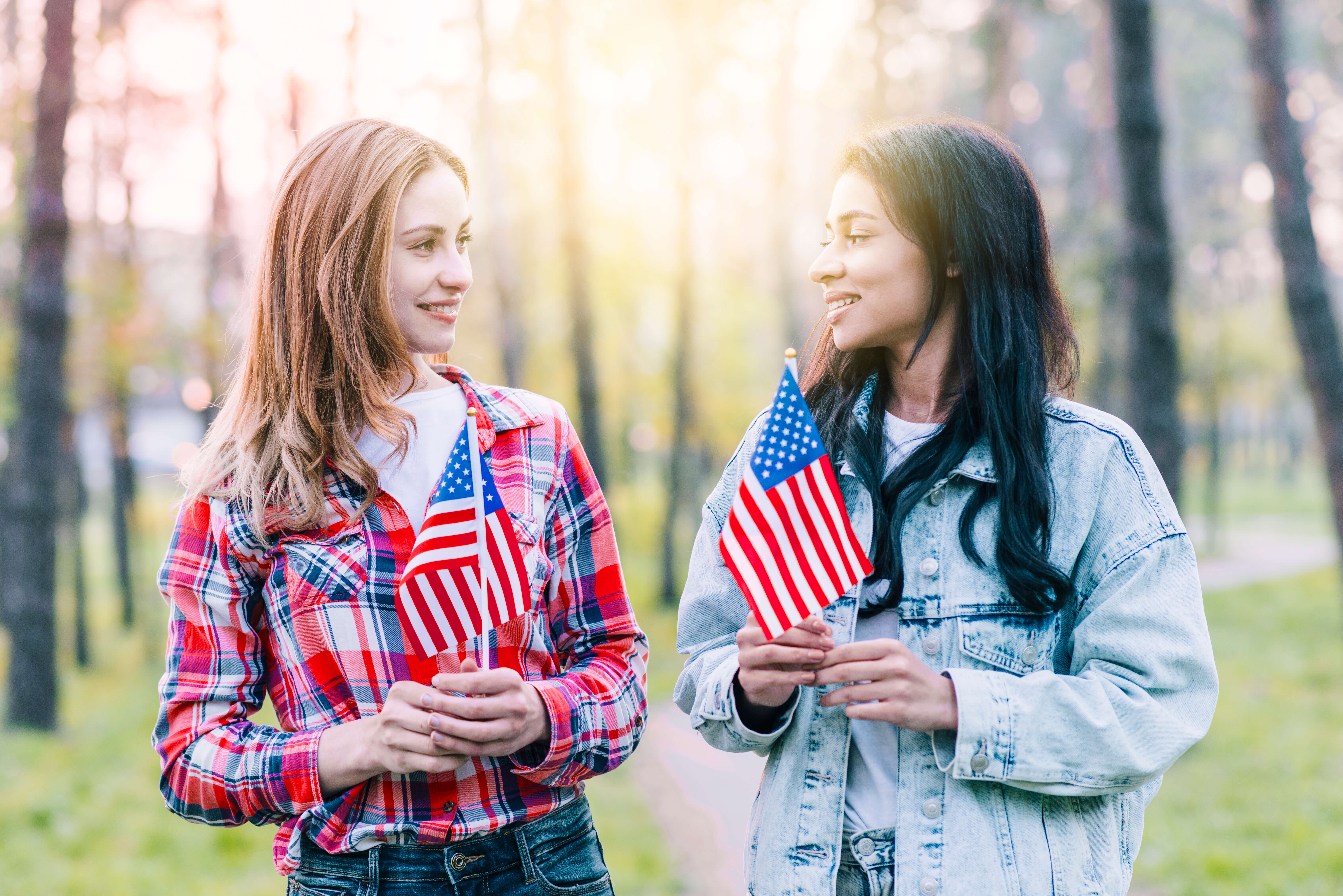 women-with-small-american-flags-standing-outdoors